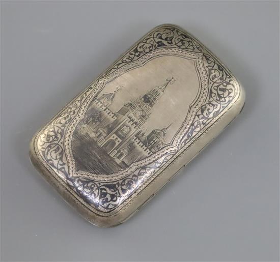 A late 19th century Russia 84 zolotnik silver and niello cigarette case, decorated with a view of the Kremlin clock tower, Moscow,